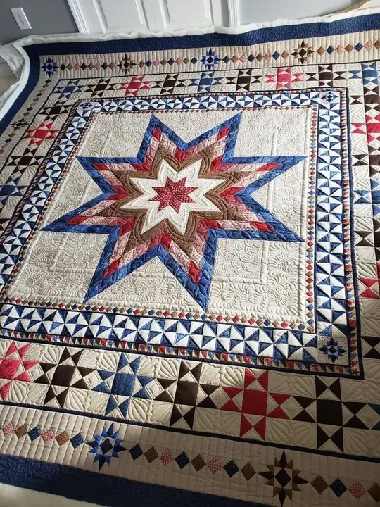 Traditional star sampler quilt hung on a wall